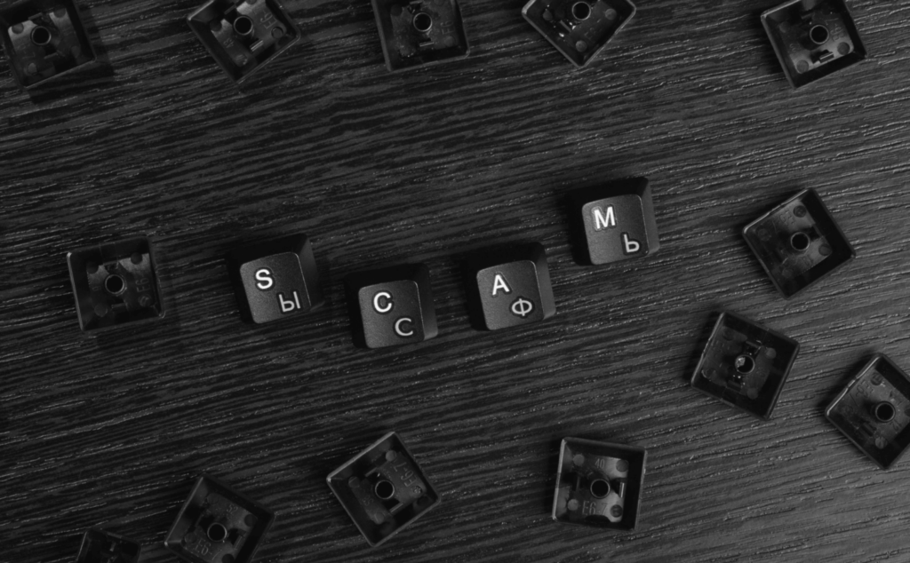 Here we have loose computer keyboard keys arranged to spell the word "scam", highlighting domain monitoring and its integration into digital risk protection as a part of modern anti-scam tactics.