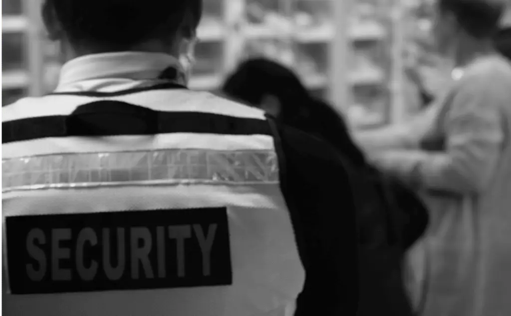 This image of a security guard in a grocery store highlights the enforcement against counterfeiting scams on Black Friday.