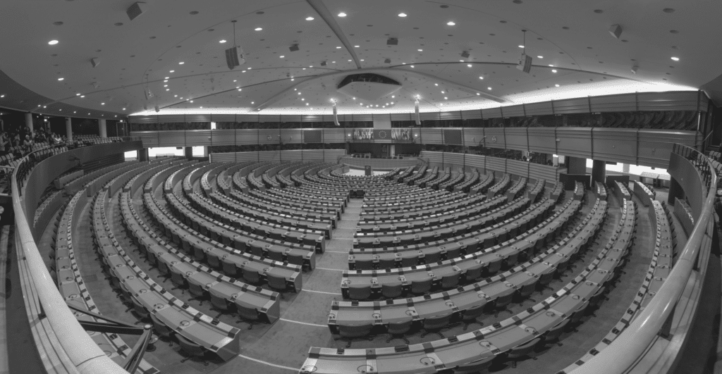 This fisheye lens image of the EU parliament highlights this article's topic of welcoming the new year's digital trends, specifically around AI and legislation.