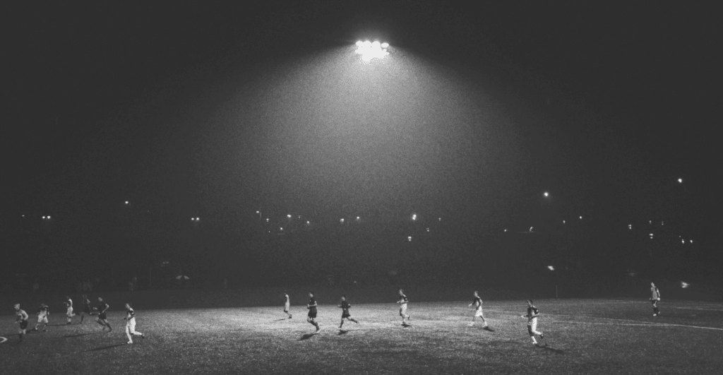 This image of footballers playing in the dark highlights the topic of this blog: online protection in football and beyond.
