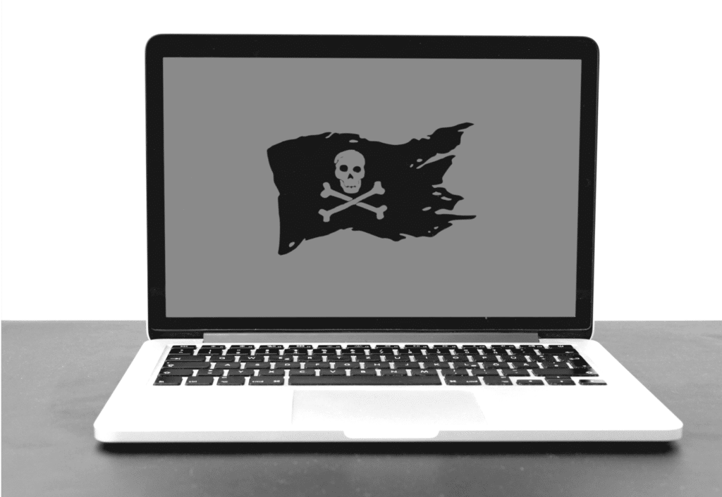 This image of a computer screen with pirate flag on it highlights the article's topic of discussion: ecommerce takedowns, and the obstacles and solutions therein.