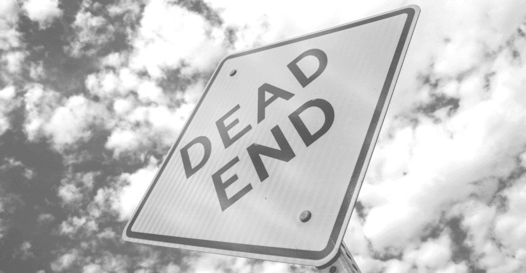 This image of road sign reading "dead end" illustrates the automotive industry section of our topic: The health hazards of counterfeits.