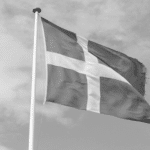 This image of the Danish flag highlights this discussion's topic: the state of scams in Denmark report.