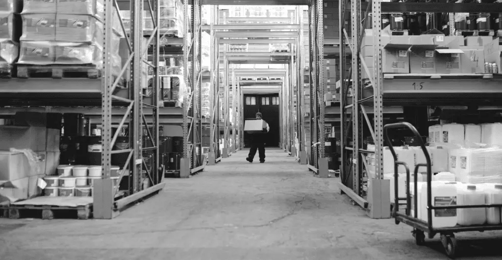 This image of a man moving a box of products out of a warehouse highlights this topic's discussion: an interview about counterfeits and product piracy.