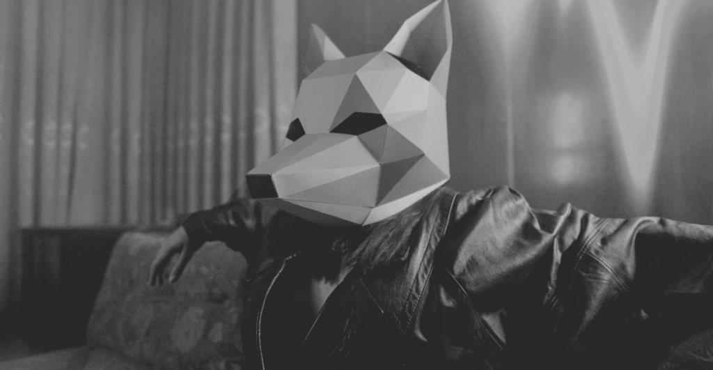 This image of a shady character relaxing in a polygonal animal mask hints at the modern forms of deception and coercion employed in modern scam tactics.