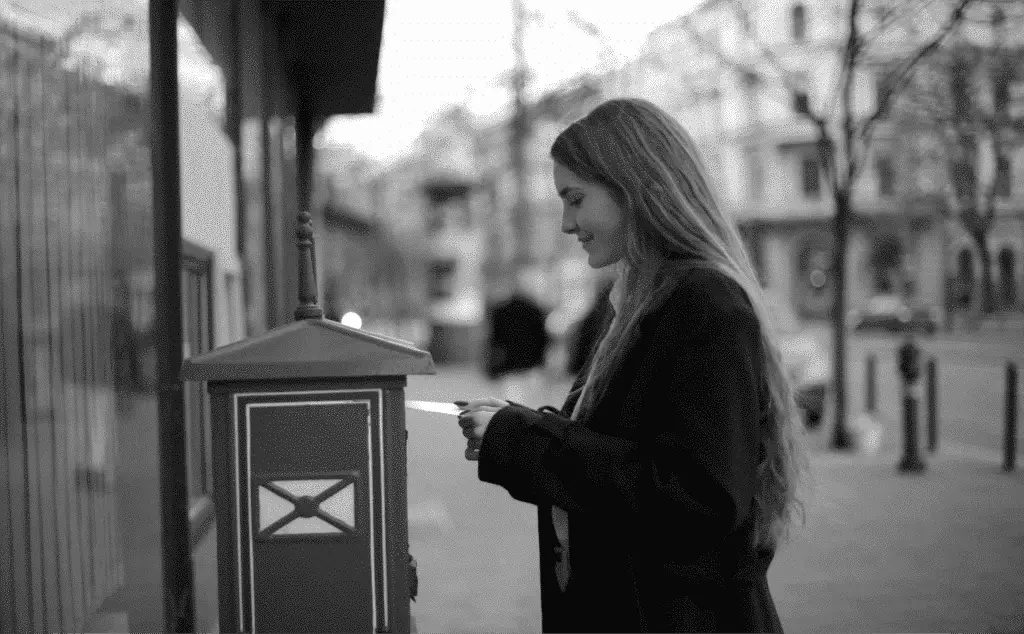 This image of a girl posting a letter highlights this post's discussion topic- The definitive domain cybersecurity checklist Part 6: Email Servers.