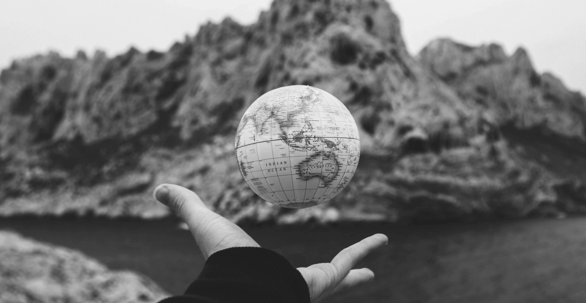 This image of a globe in someone's hand over a precipice highlights the global dangers of our discussion topic: the top ten most dangerous ccTLDs (country code top level domain extensions).