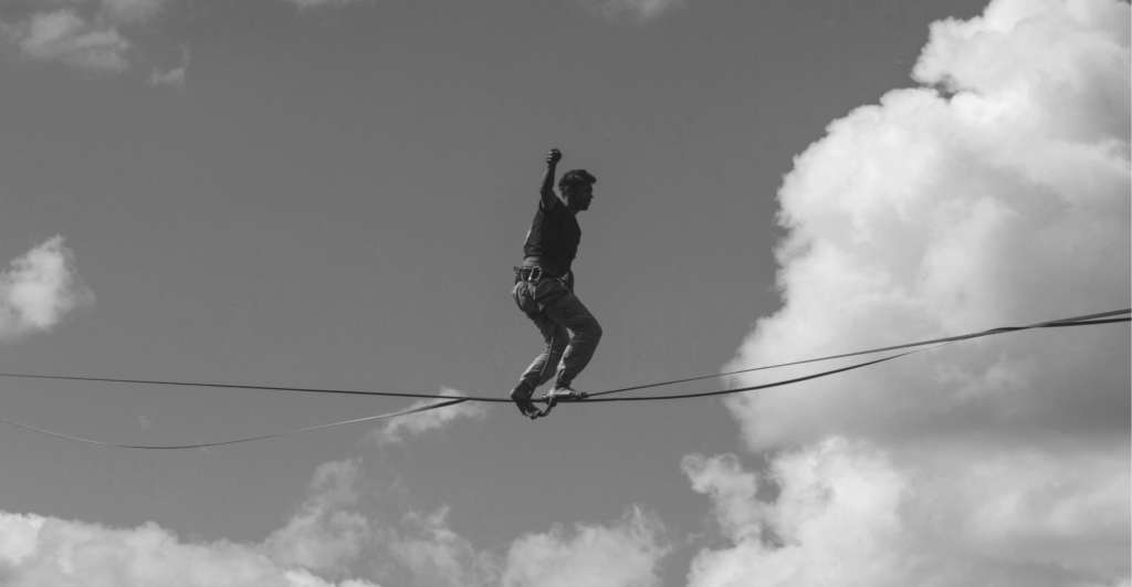 This image of a tight rope walker in the clouds illustrates this guide's discussion topic: the pitfalls of brand protection.