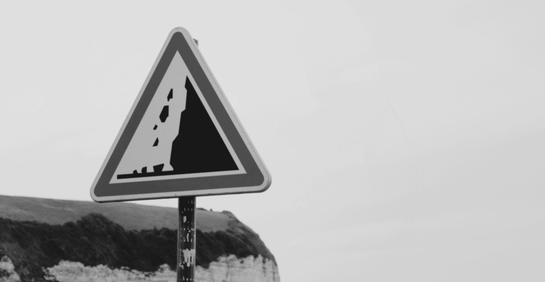 This image of a warning sign on the edge of a cliff illustrates this guide's discussion topic: the pitfalls of brand protection.