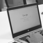 This image of a person's hand at a computer about to Google something illustrates our post's dicussion topic on how to remove google search results, and other brand protection tactics.