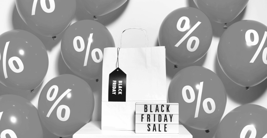 This image of text saying "Black Friday Sale", along with percentage balloons and a shopping bag illustrates our discussion topic: The scams targeting brands around Black Friday Sales, and how to stop them.