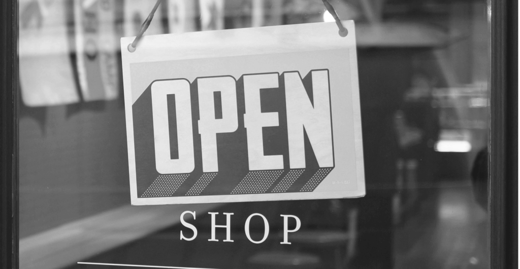 This image of an open shops sign illustrates our discussion topic: The scams targeting brands around Black Friday Sales, and how to stop them.