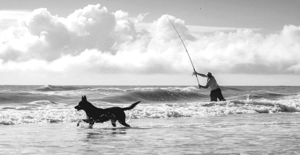 This image of a fisherman and his dog illustrates our discussion topic: Threat hunting, and how it helps brands develop smart protection strategies to fight cyberattackers and protect their businesses.