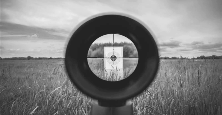 This image of a scope and a target illustrates our discussion topic: Threat hunting, and how it helps brands develop smart protection strategies to fight cyberattackers and protect businesses.