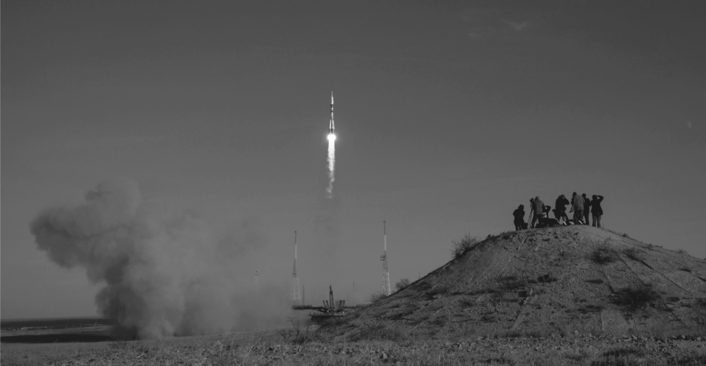 This image of a group of onlookers witnessing a rocket launch highlights the complexity of domain management, with a specific focus on EBRAND's COSMOS domain platform.