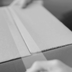 This image of a box being sellotaped shut highlights this piece's discussion topic: The importance of a test purchase for Online Brand Protection.