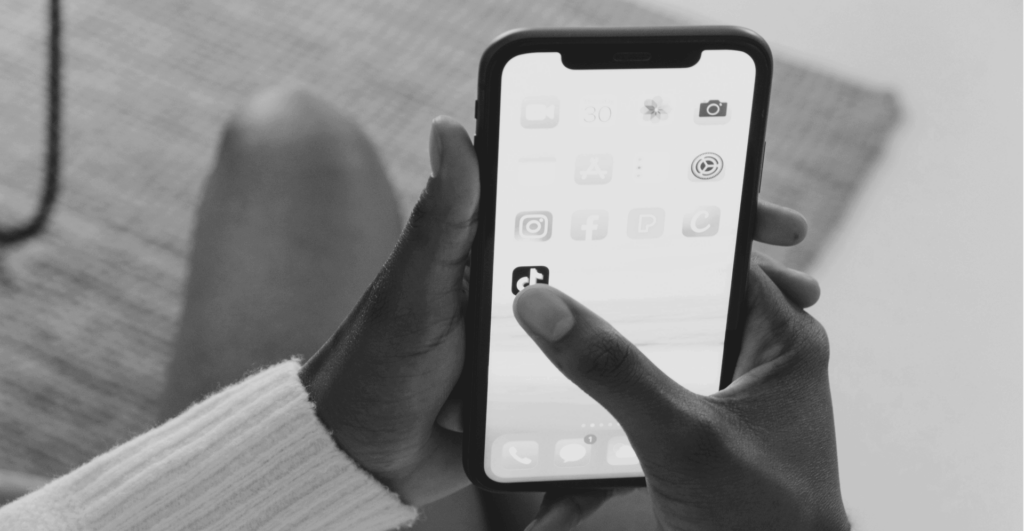 This image of someone selecting the TikTok app on their phone highlights our discussion topic: TikTok Shop, and the threats it poses for brands in terms of infringements, counterfeits, and ecommerce revenue.