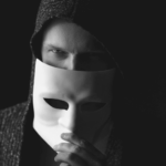 This image of a shady hooded figure in a mask illustrates our discussion topic: Darcula, the phishing as a service kit, and how understanding its nuances boosts your cybersecurity resilience.