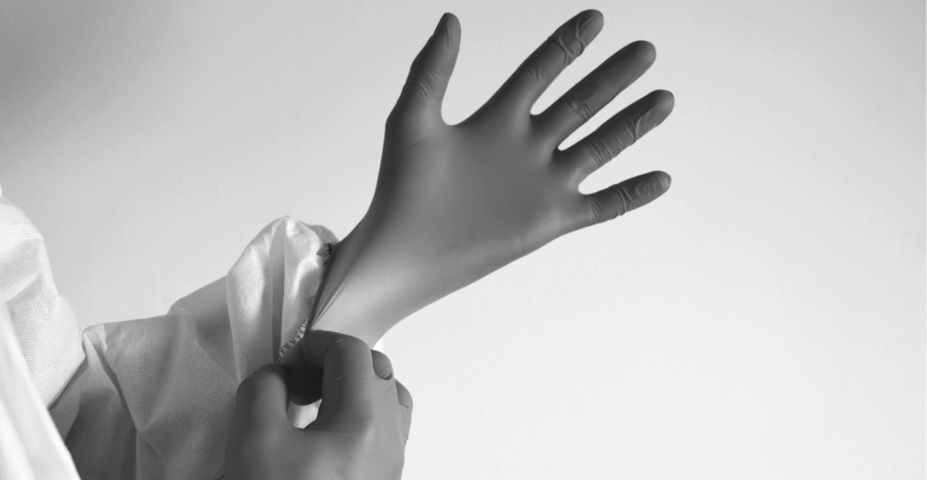 This image of gloved hands highlights our discussion topic: Cyber hygiene, how businesses undervalue it, and its potential for digital risk protection.