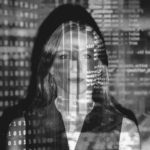 This image of a woman overwritten by code illustrates our discussion topic: Agentic AI, the relevance of autonomous phishing for modern businesses, and how to tackle it with Digital Risk Protection.