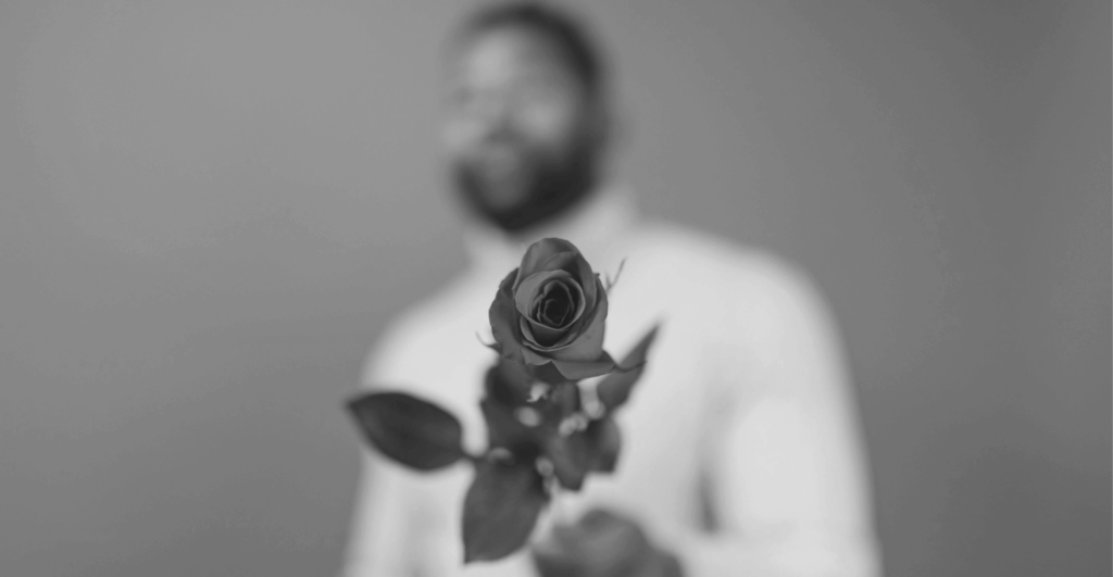 This image of a man offering a rose illustrates our discussion topic: Fake websites and Valentine's Scams.