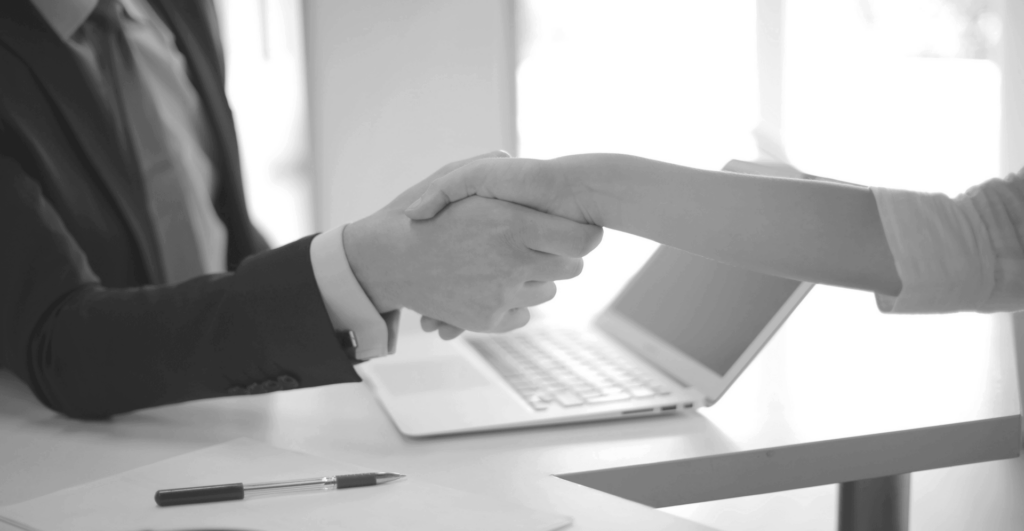 This image of two colleagues shaking hands illustrates our discussion topic: Takeaways from ICANN 85 in Mumbai, ahead of the next round of new gTLDs.