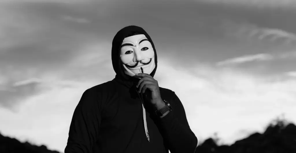 This image of a masked man illustrates our discussion topic about digital risk protection top tips.