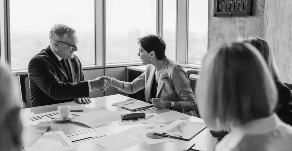 This image of a corporate handshake illustrates our discussion topic: the WIPO World IP Day, the IACC, and global brand protection,